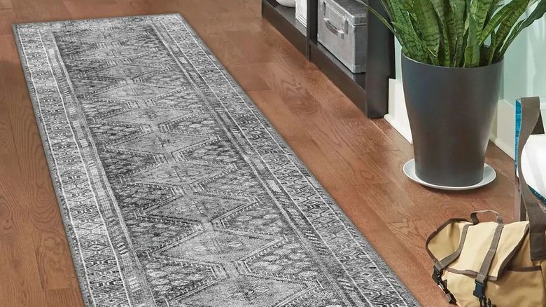 Gray runner rug next to house plant