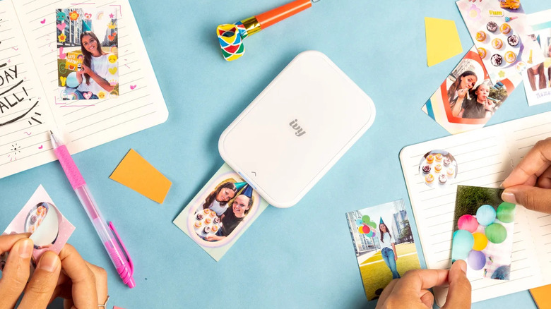Top down view of photo printer and crafts