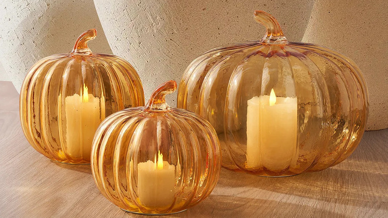 Decorative glass pumpkins with candles inside