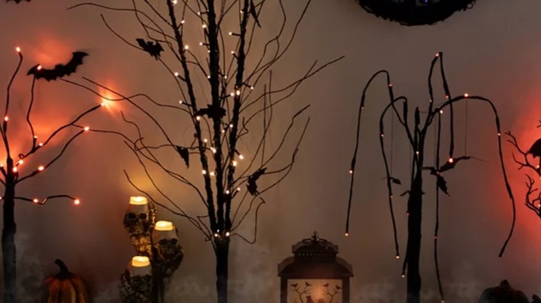 Macy's LED Halloween tree amid other spooky Halloween decorations