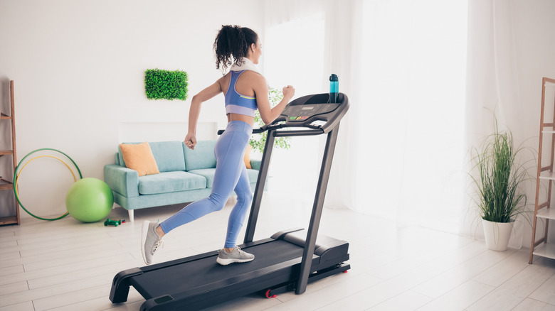person running on treadmill at home