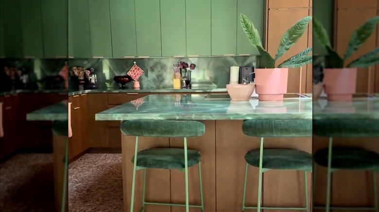 A kitchen with green emerald backsplash and brown cabinets