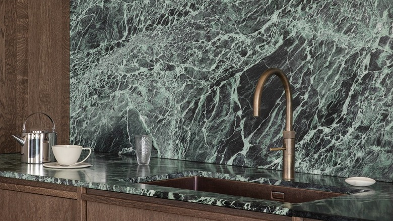 A green marble backsplash and countertop