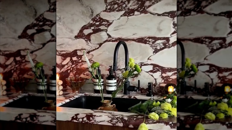 Pinkish-red calacatta viola marble behind a sink