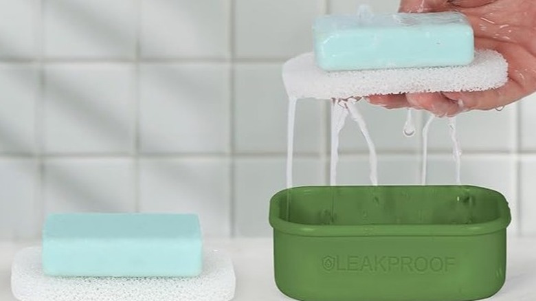 Woman holding a wet soap and drainage bar over a green case