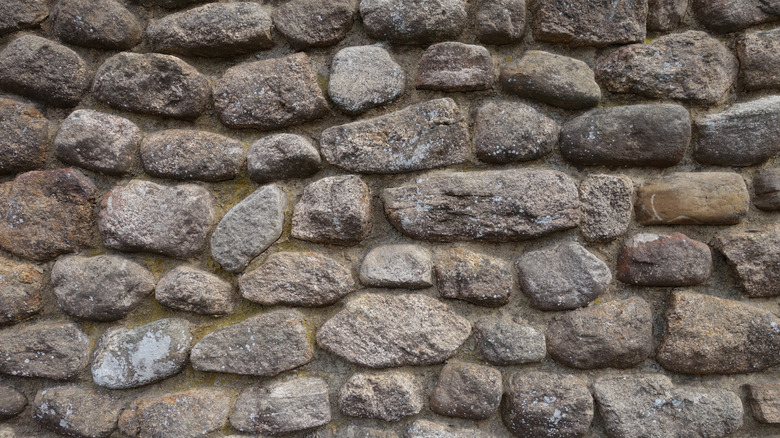 Close up of granite stone wall with brown and grey colored stones