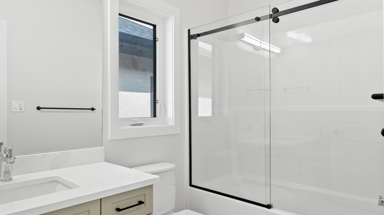 clear glass shower door built into bath tub