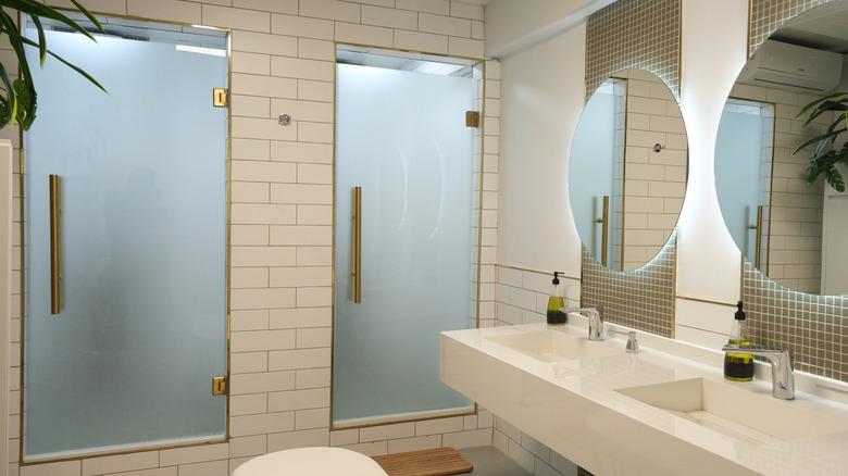 shared bathroom space with opaque glass shower doors