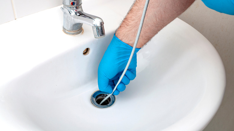 Using plumber's snake to unblock drain