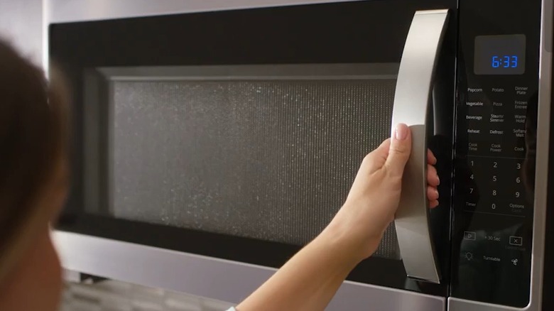 a whirlpool microwave installed over a range