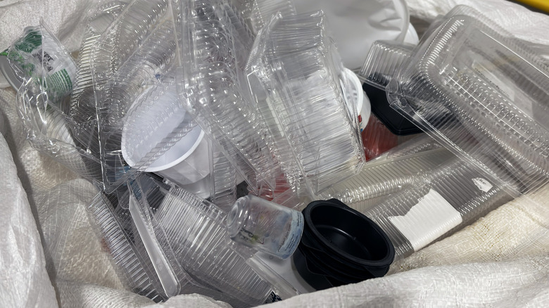 Deli containers at the supermarket are filled with cold salads and stacked on shelves