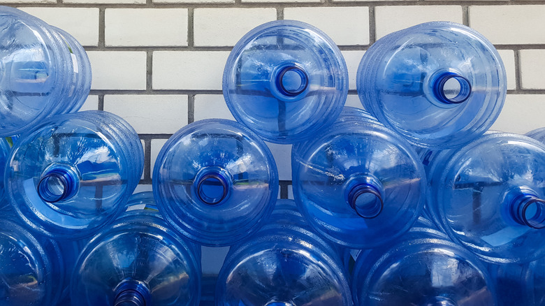 A stack of empty water cooler jugs