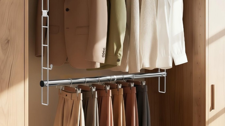 Hanging closet rod holding pants on hangers