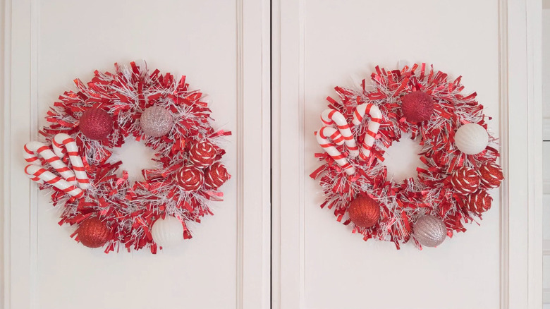Red and white tinsel wreaths with candy cane ornaments