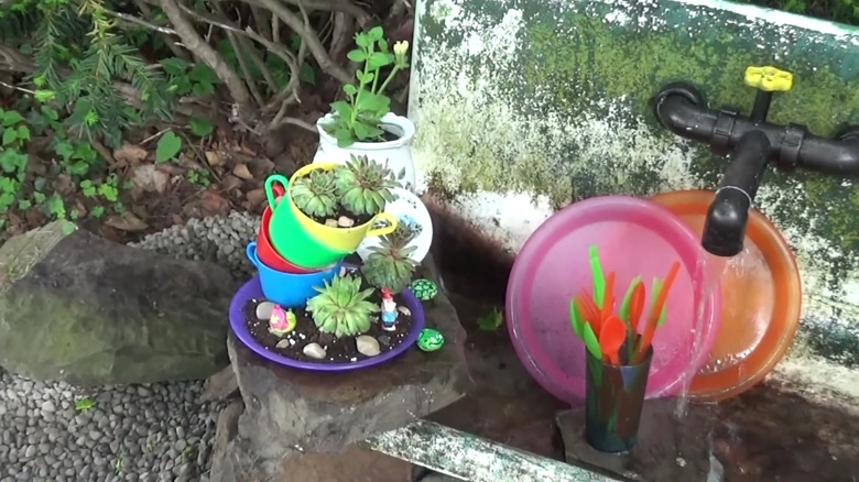 Stacked teacups as a planter outside