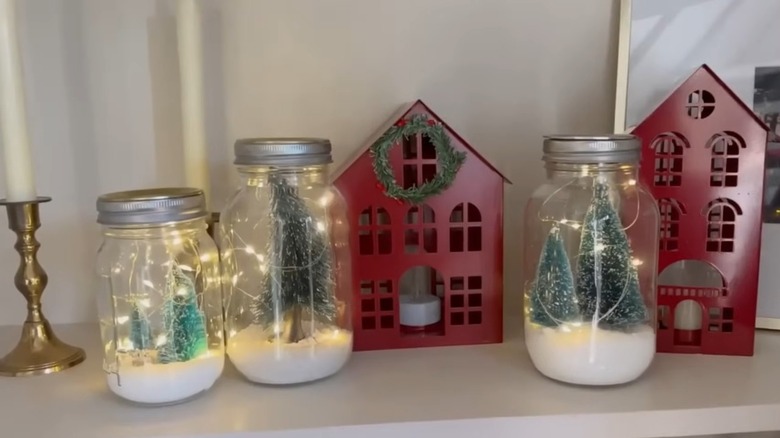 Bottle brush trees inside jars with solar panel lids and fake snow