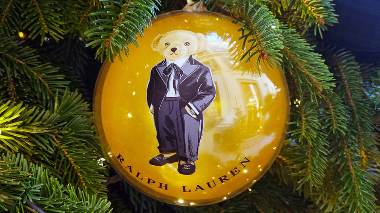 A Christmas bauble on a tree with an illustrated bear and the Ralph Lauren logo printed on it