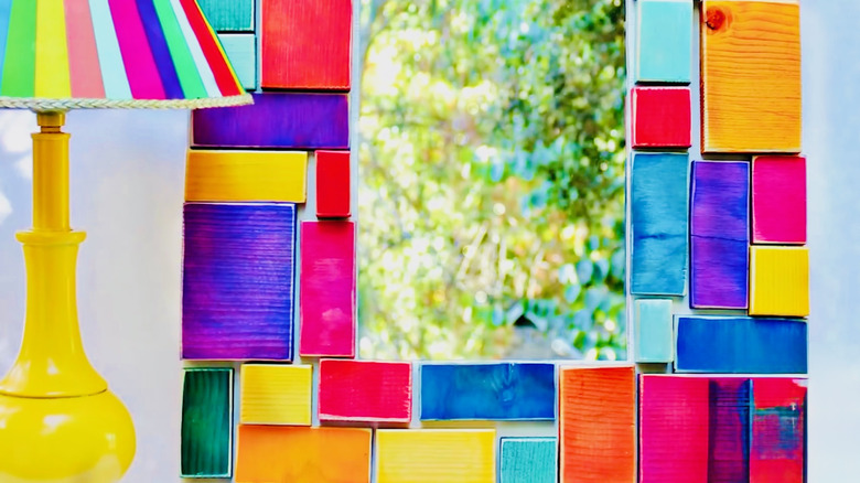 A DIY mirror with colorful blocks made from painted wood scraps