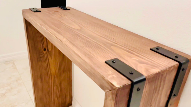 A DIY console table made from wood scraps and metal brackets