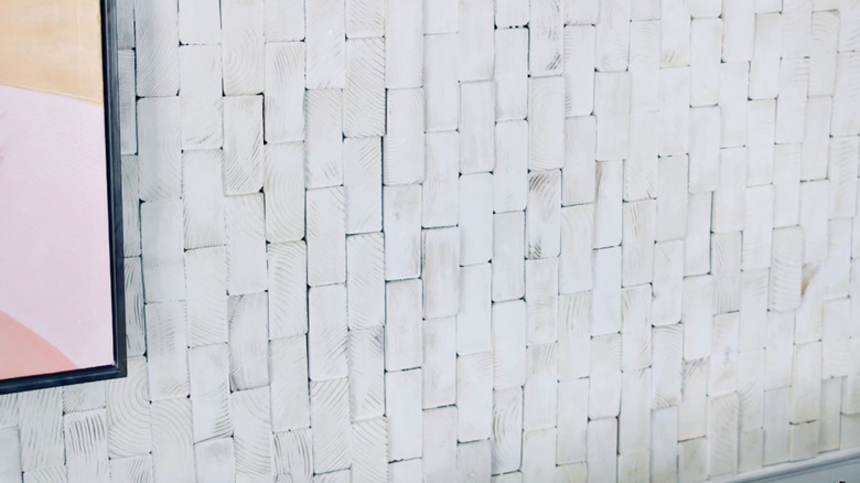 A DIY accent wall made from wood scraps painted white