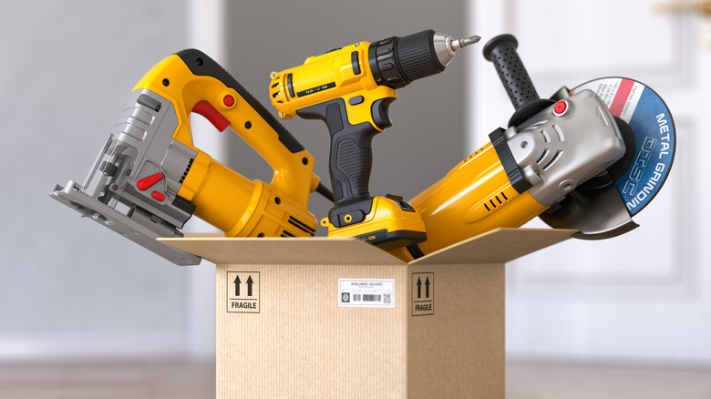Power tools stacked in a cardboard box