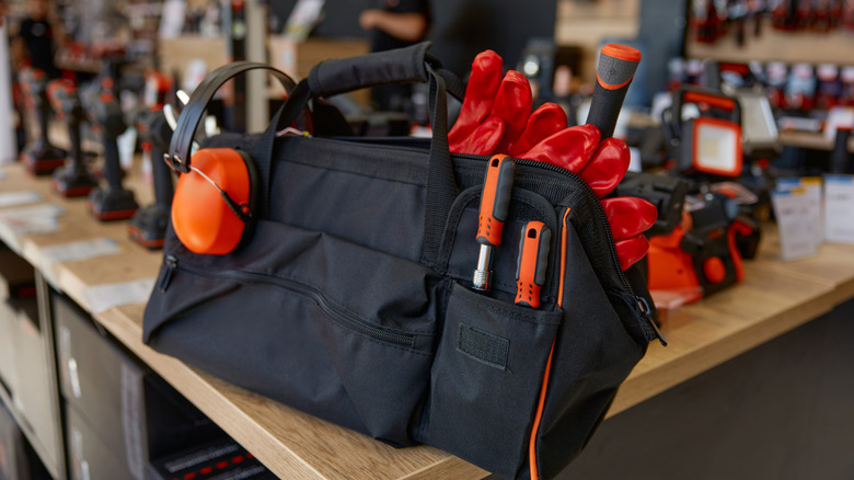 Tool bag on a workbench filled with essential tools