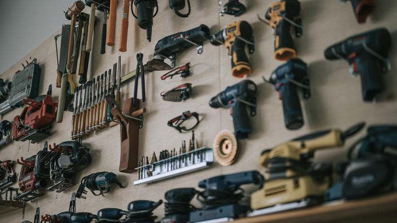 Pegboard tool storage with several tools on pegs