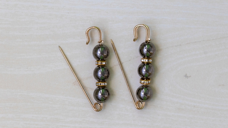 Safety pin gold earring or brooch made with black and gold beads
