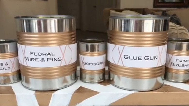 A set of storage containers made from upcycled tin cans.