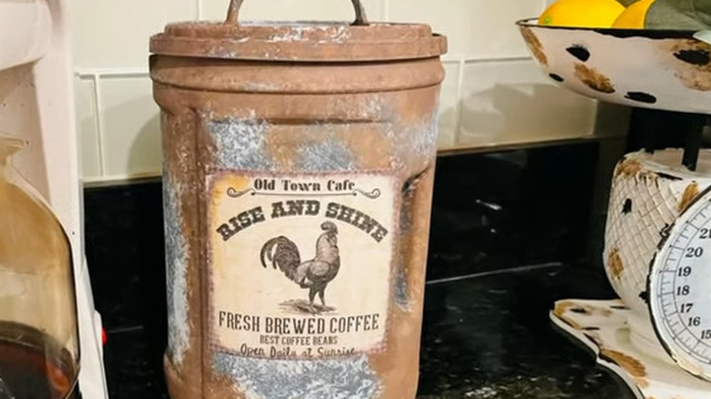 A plastic coffee can with farm house decor.