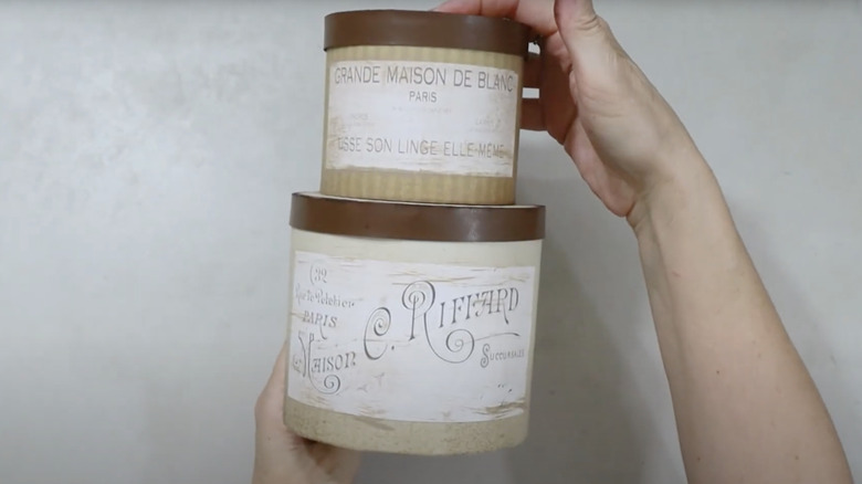Decorative storage containers made from oatmeal containers.