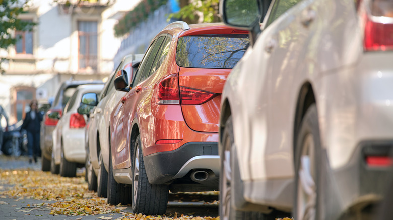 Many cars parked in line on street side