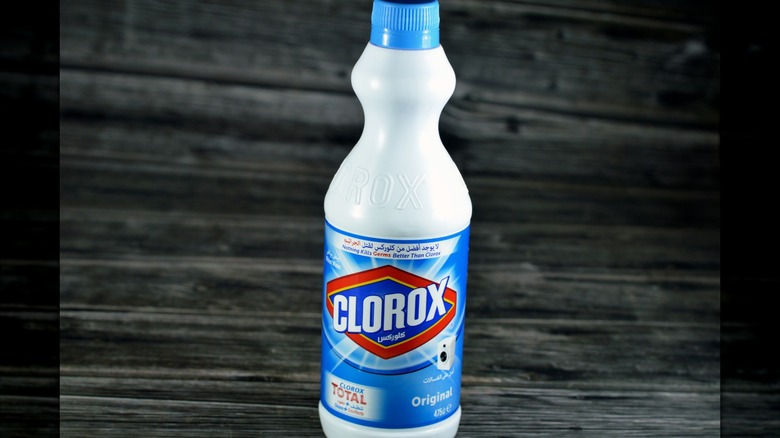Bottle of bleach on a wood table