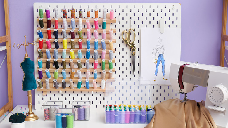A pegboard used for organization in a sewing room.