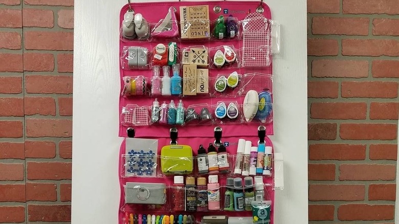 An over-the-door shoe organizer used to store craft room supplies.
