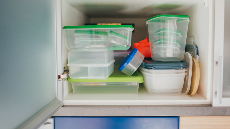 A messy food container shelf in a kitchen