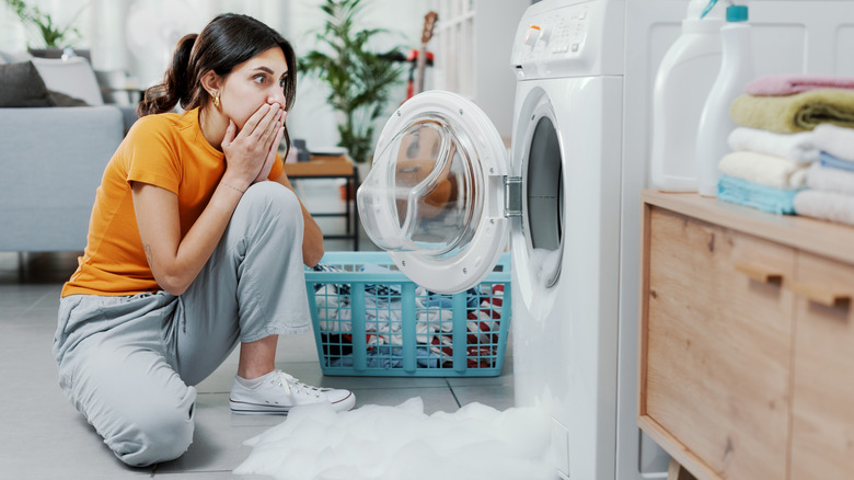Woman with a leaking washing machine