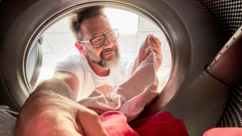 Man noticing clothes aren't drying