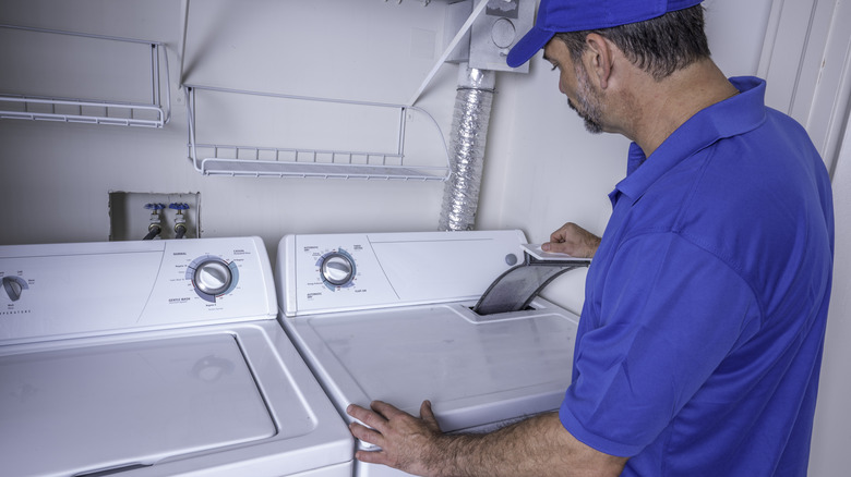 Man fixing clothes dryer