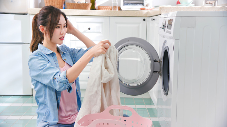 Woman upset clothes wont spin in washing machine