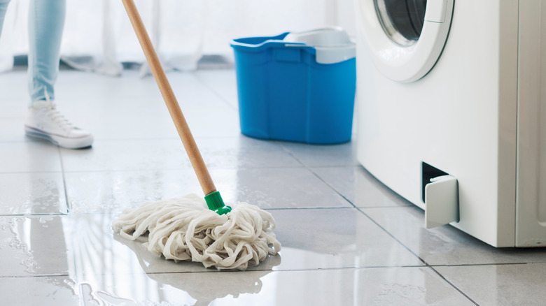 Mopping floor after water was leaking from washing machine