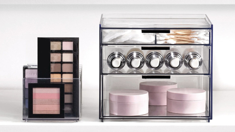 Part of iDesign's cosmetic organizer set holding lipstick and makeup palettes