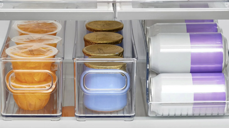 Three of the four bins in iDesign's kitchen bin set holding cups and cans