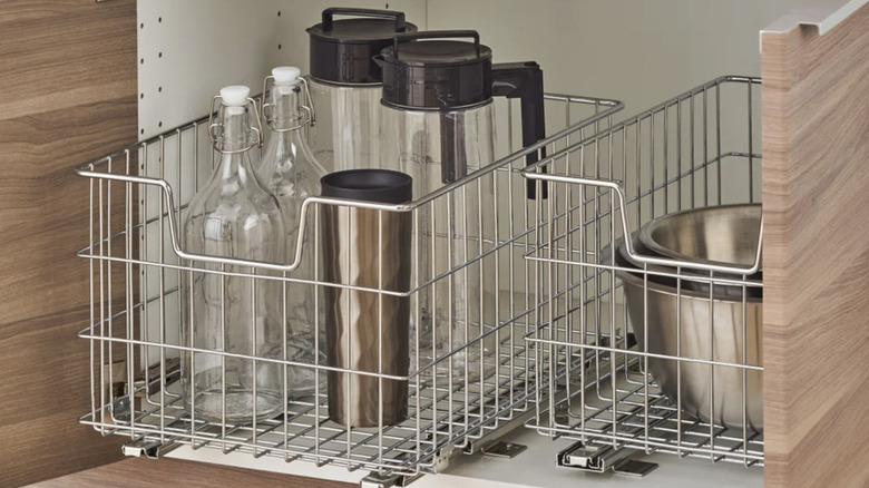 Trinity's wire baskets holding kitchen items in a cabinet