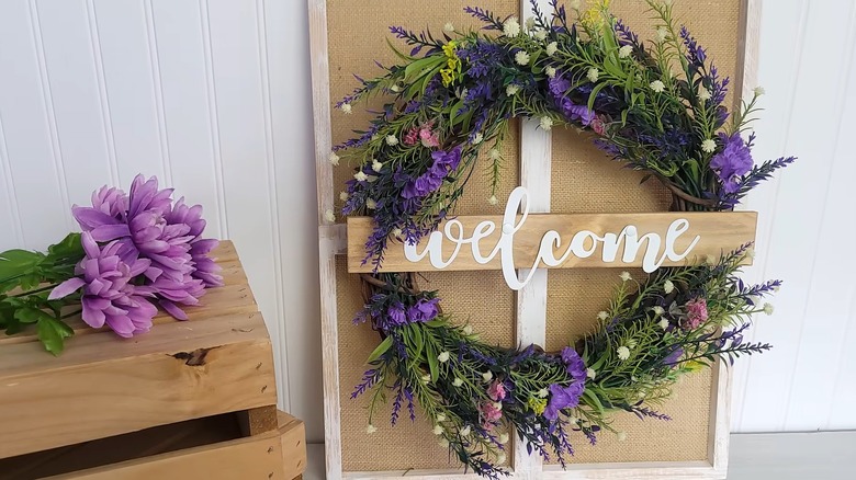 A floral wreath with a welcome sign across it