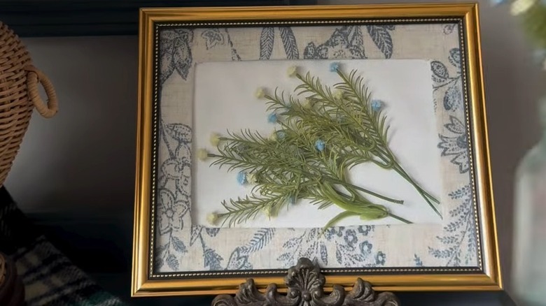 Small flowers pressed inside a photo frame
