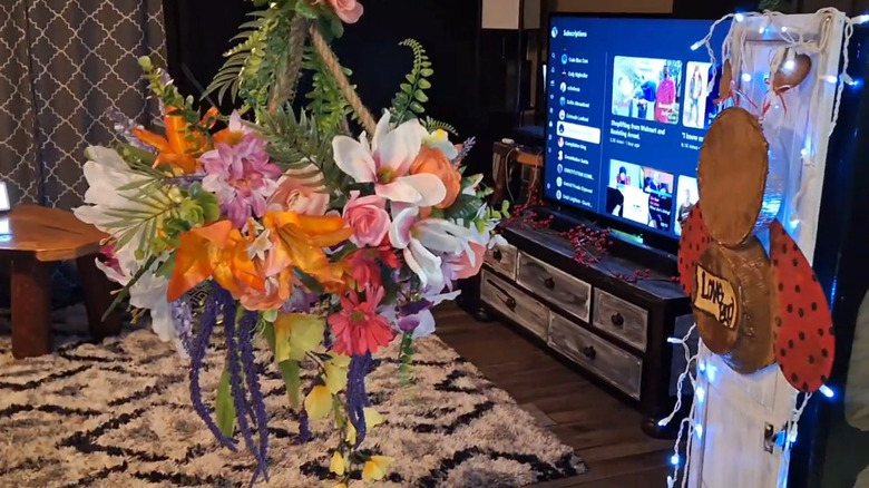 A flower chandelier hanging from a rope