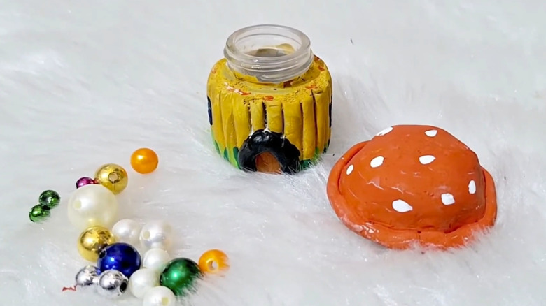 Mushroom jar with lid off on fur background