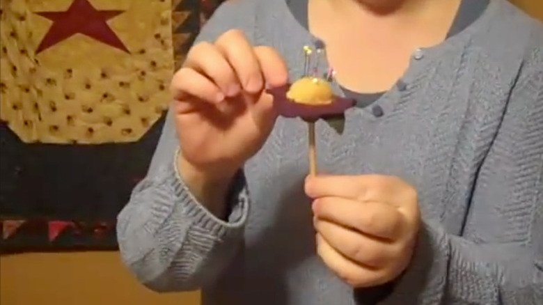 DIY pincushion made with an old golf tee