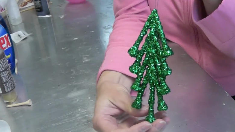 A green glitter Christmas decoration made from golf tees